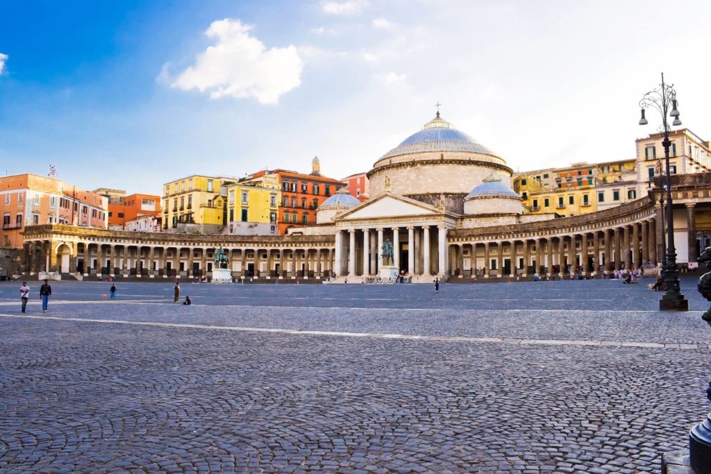 best photo spots in piazza plebiscito naples showing the massive circular stone colonnade under dramatic morning sky patterns cleanly