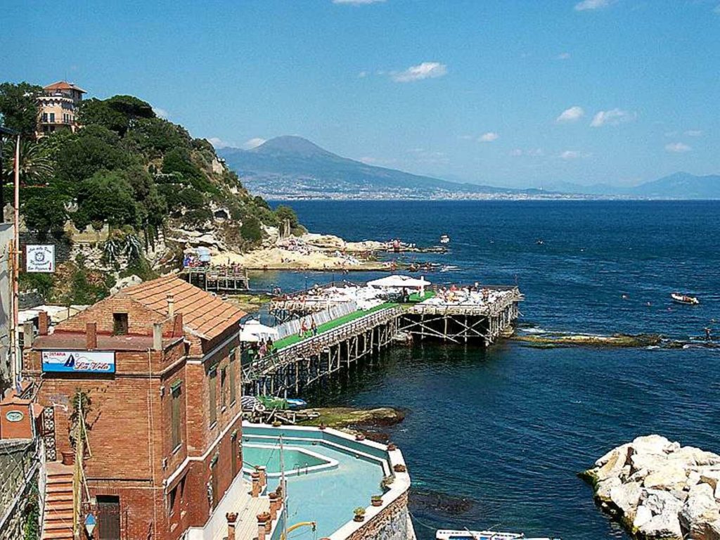 marechiaro napoli showing small traditional wooden fishing boats floating on crystal clear turquoise water cleanly