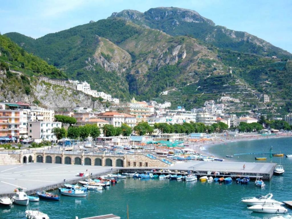 il momento migliore della giornata per visitare il lungomare di maiori che mostra l'ampia passeggiata costiera decorata con alte palme