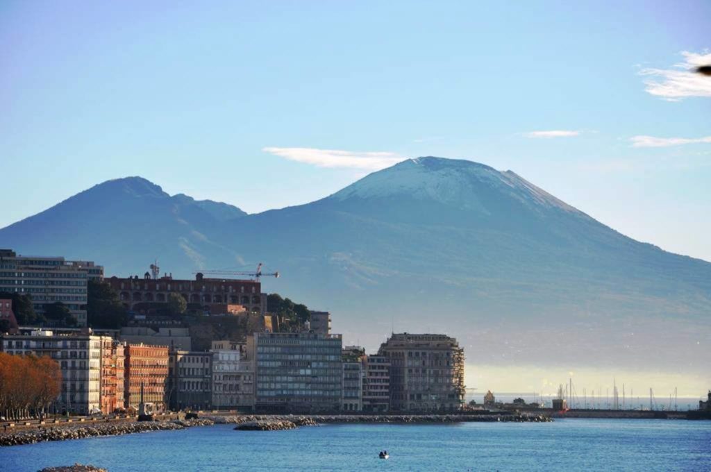 best time of day to visit via franseco caracciolo napoli showing dramatic pink sunset clouds over the bay