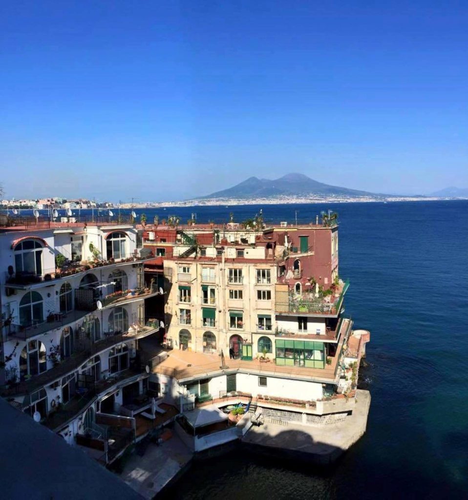 naples photography spots showing the panoramic view of the gulf and mount vesuvius framed by a stone pine tree in posillipo