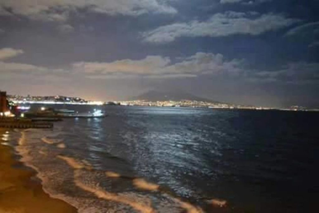 spiaggia di posillipo naples where locals actually go showing the dark volcanic sand and ancient roman ruins