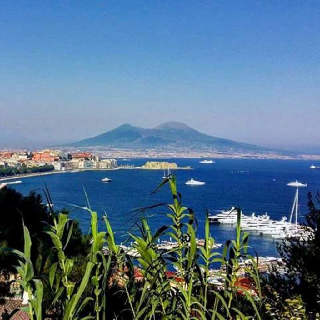 naples photography spots featuring the classic stone archways of virgiliano park framing the blue horizon