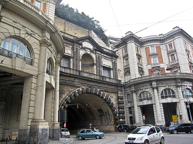 is galleria della vittoria safe at night naples brightly lit concrete tunnel interior with trailing car headlights