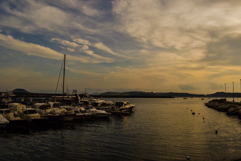 naples hidden gems porticciolo pozzuoli italy small harbour fishing boats ancient stone morning intimate