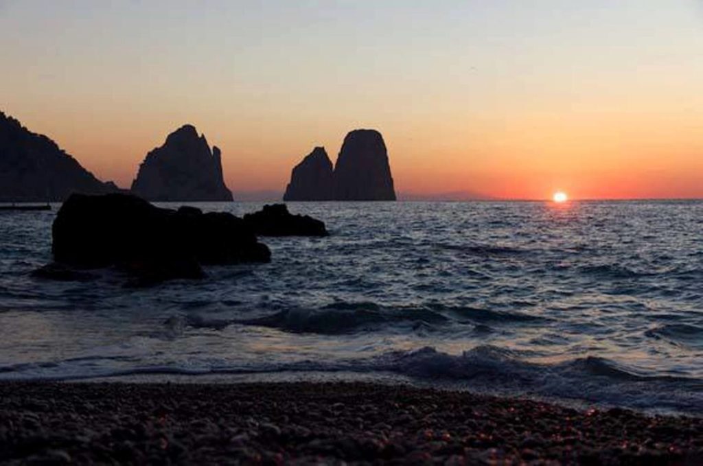 caletta capri faraglioni naples photo spots highlighting the sweeping coastal harbor curves with cliffs rising cleanly across the bay