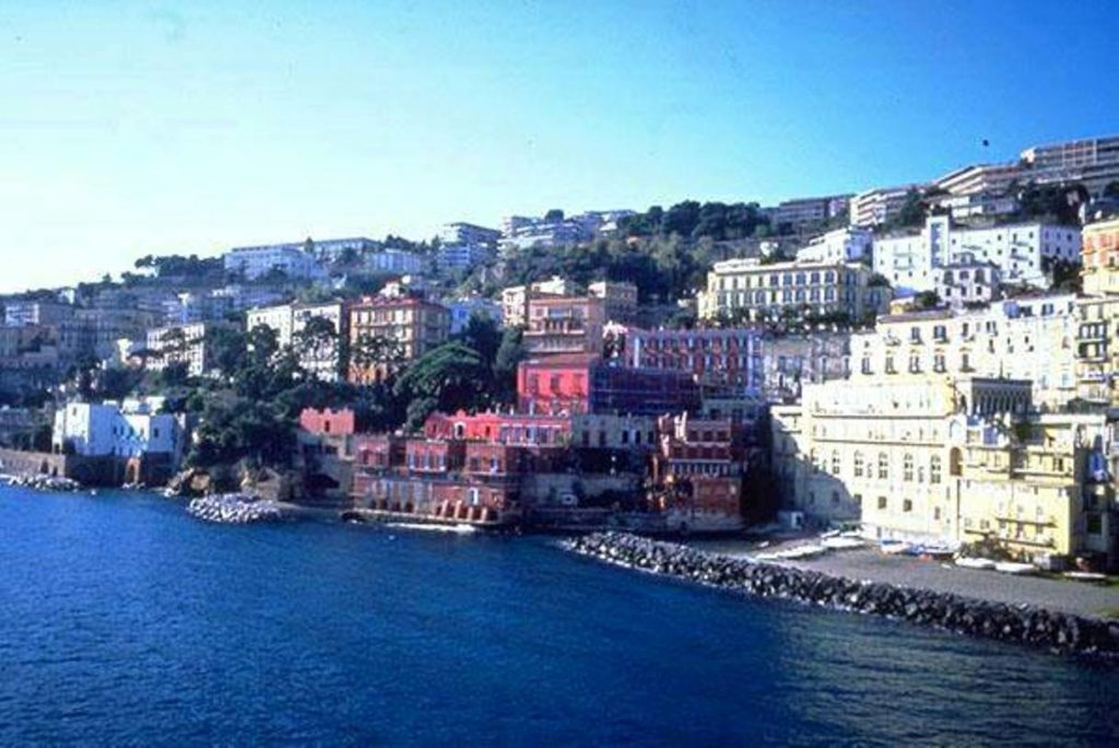capo posillipo spiaggia napoli photo spots highlighting the sweeping coastal harbor curves with cliffs rising cleanly across the bay