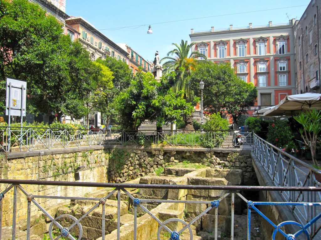 piazza bellini napoli photo spots featuring the ancient exposed roman greek stone walls surrounded cleanly by outdoor cafes