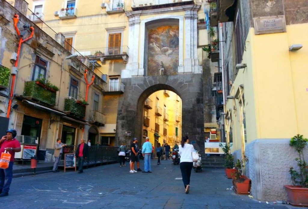 via foria porta san gennaro napoli photo spots featuring the ancient stone gateway arch with historic frescoes preserved cleanly