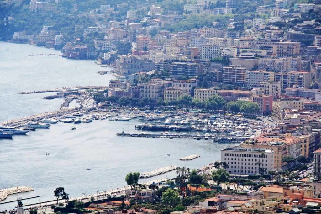 gulf naples mergellina photo spots showing the wide blue bay waters stretching toward the volcanic peak cleanly