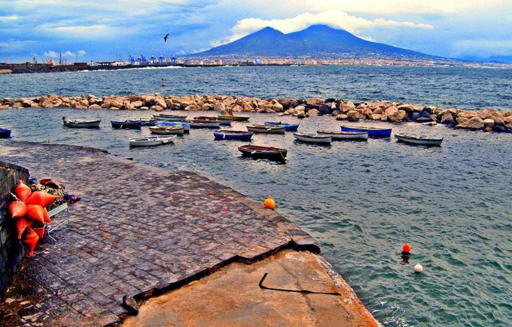 colonna spezzata piazza vittoria photo spots showing the monumental broken marble column standing tall next to the sea cleanly