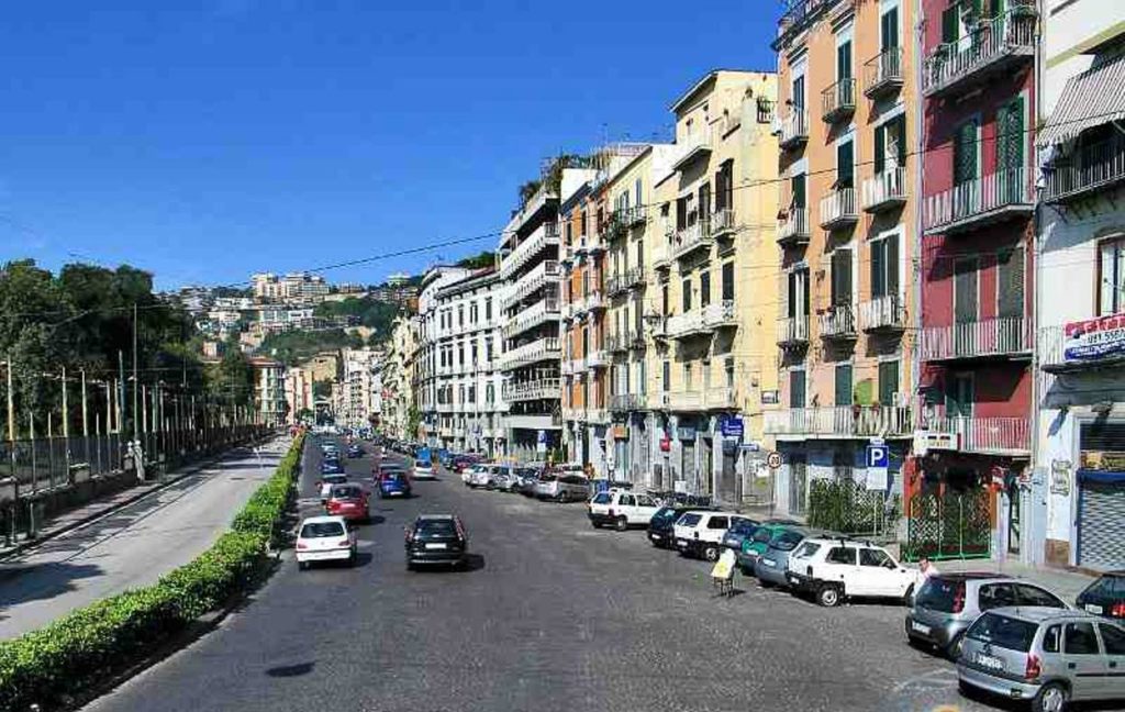 best photo spots in riviera di chiaia napoli showing rows of grand neoclassical palaces lining the wide elegant public avenue cleanly